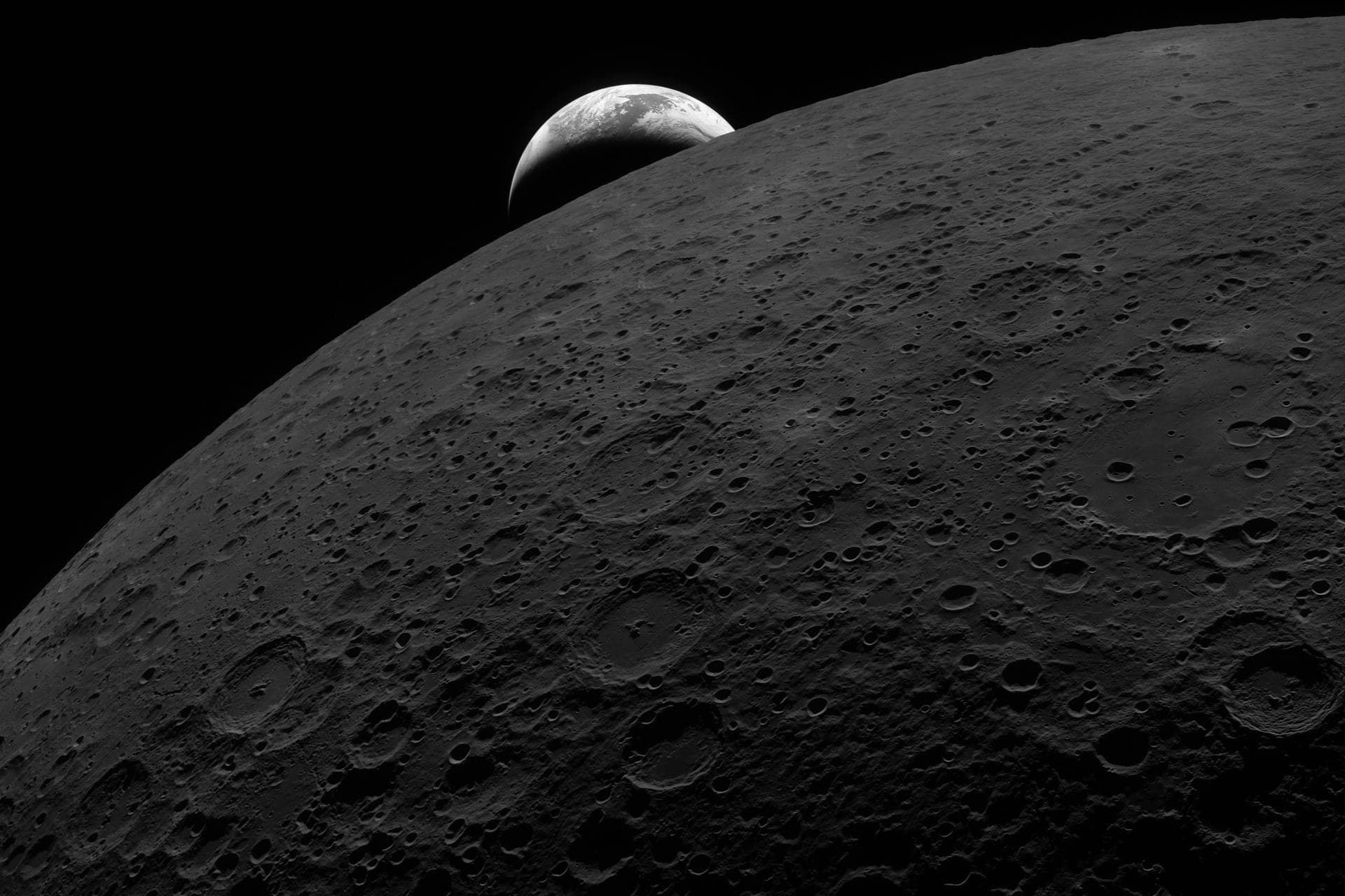 Earth rising over the lunar horizon