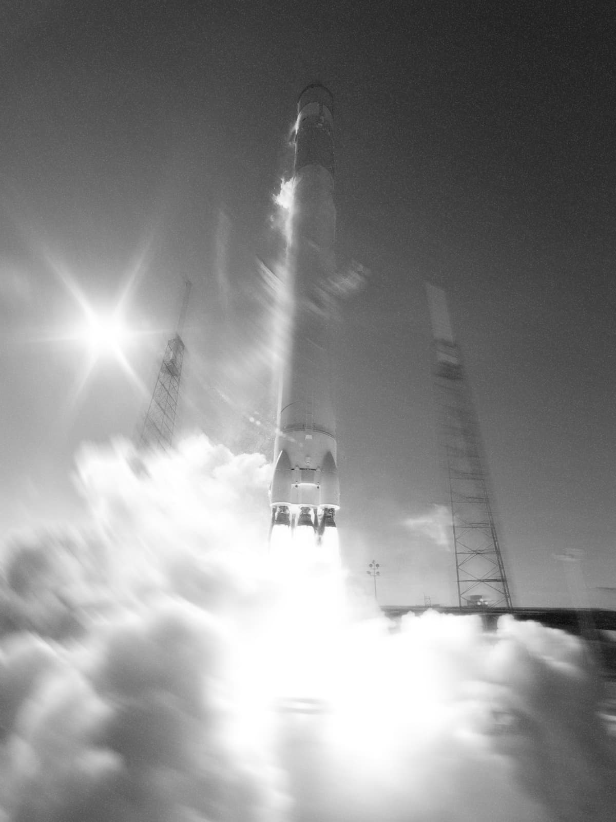 Rocket lifting off through exhaust clouds
